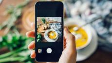 Person taking photo of food with a smartphone